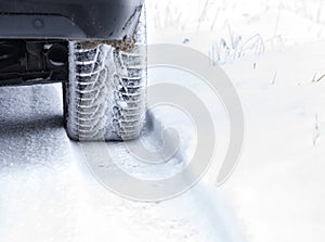 Winter Tyre on snowy country road.