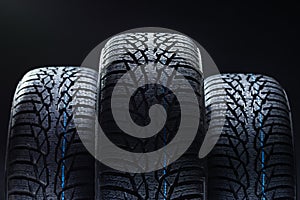 Winter tyres on black background with contrasty lighting