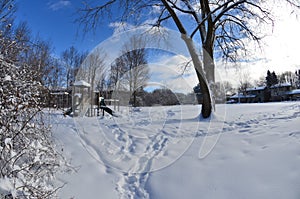 Winter urban city landscape - a snow-covered playground in a residential area in Canada