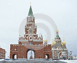 Winter urban landscape with snow from buildings and Orthodox Church