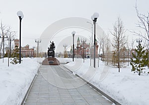 Winter urban landscape with snow from buildings and Orthodox Church