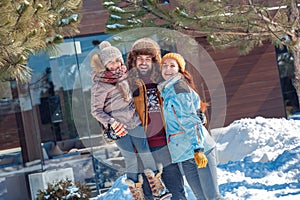 Winter vacation. Family time together outdoors father holding daughter up laughing happy