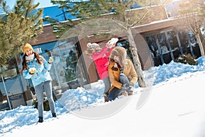 Winter vacation. Family time together outdoors playing snowballs cheerful