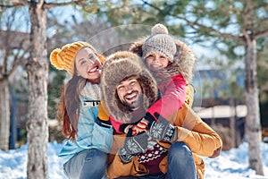 Winter vacation. Family time together outdoors sitting hugging laughing cheerful close-up blurred background