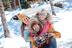 Winter vacation. Family time together outdoors sitting hugging laughing playful