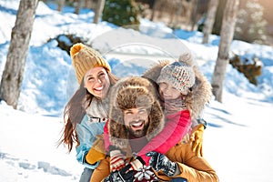 Winter vacation. Family time together outdoors sitting hugging laughing playful