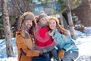 Winter vacation. Family time together outdoors sitting hugging smiling happy