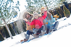 Winter vacation. Family time together outdoors sitting throwing snow laughing cheerful