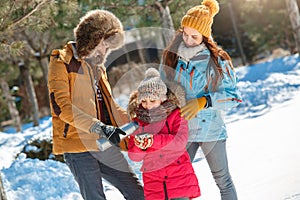 Winter vacation. Family time together outdoors standing man pouring hot tea into girl`s cup smiling joyful