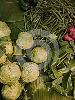 Winter vegetables kept in retail storefront for sale in bengal india. green cabbage, dolichos beans, carrot and other seasonal