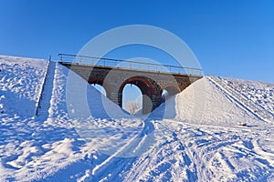 Winter viaduct after heavy snowfall. The concept of transport communication during winter