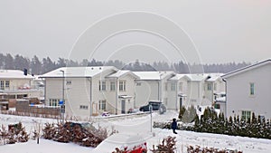 Winter view of country village with white houses covered with snow. Beautiful landscape background.