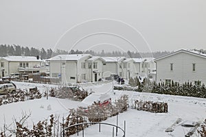 Winter view of country village with white houses covered with snow. Beautiful landscape background.
