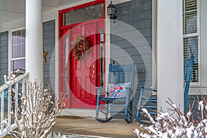 Winter view of home with red door and front porch