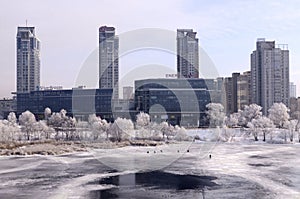 Winter view of Kiev city and the Dnieper river, fishermen ice fishing