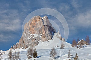 Winter view of Mount Averau which stands isolated by snow-covered meadows