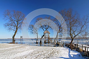 Winter view of river in snow, Biebrzanski National Park, Poland.