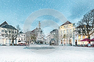 Winter view with snowfall of the central square in the historic Dutch city Deventer photo