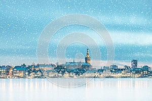 Winter view with snowfall and ice of the Dutch city of Nijmegen in Gelderland with the river Waal photo