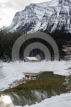 Winter view of a wooden cabin at Lake Louise