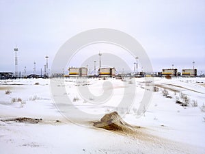 Winter view of the workshop for the preparation of oil. Reservoirs with oil.