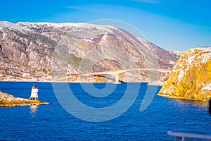 Winter views of wooden houses and stoned bridge in the coast from Hurtigruten voyage, Northern Norway