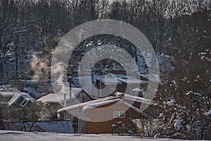 winter village scenery with smoke coming from house chimneys