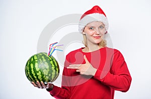 Winter vitamin fruit ration. Detox after christmas. Strengthen immunity concept. Girl wear santa hat drink watermelon