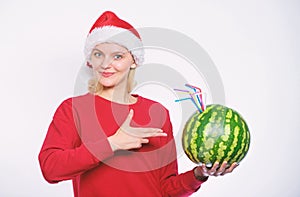 Winter vitamin fruit ration. Detox after christmas. Strengthen immunity concept. Girl wear santa hat drink watermelon