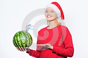 Winter vitamin fruit ration. Strengthen immunity concept. Girl wear santa hat drink watermelon vitamin cocktail straw