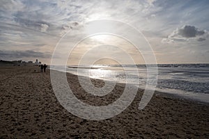 Winter walking on wide sandy beach of North sea near Zandvoort in Netherlands