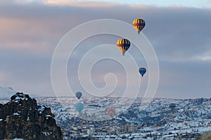 Winter warm dawn with red balloon on hotfire balloons festival, cappadocia, turkey, kappadokya