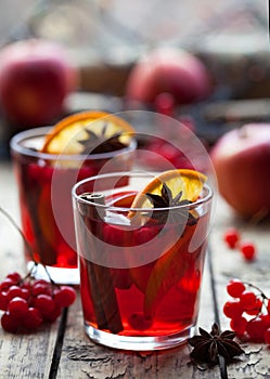 Winter warm drink. Christmas mulled red wine or sangria with cinnamon sticks, anise stars, oranges and berries in a pot.