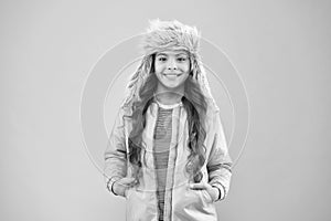 Winter warmness. kid fashion. trendy girl look like hipster. fur earflap hat accessory. small girl winter hat. happy kid