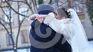 Winter wedding. newlywed couple in wedding dresses. newlyweds kiss, hug. romantic kiss of lovers. they are happy
