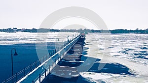 Winter Wisconsin trestle trail bridge over lake