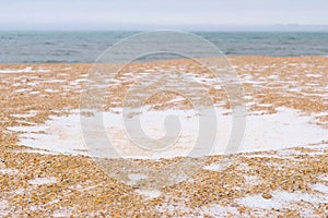 Winter witn snow on the sea sand beach. Beautiful seascape.