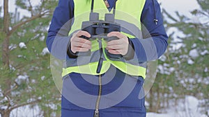 Winter woman with binoculars in forest