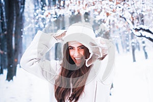 Winter woman fan. Christmas winter holidays concept. Outdoor close up portrait of excited young beautiful girl snowball