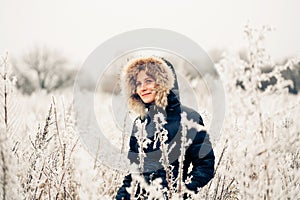 Winter woman in a frozen plant