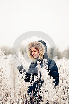 Winter woman in a frozen plant