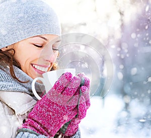 Winter woman with hot drink outdoors