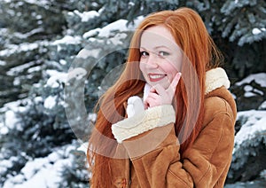 Winter woman outdoor portrait, smiling and show finger