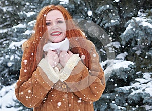 Winter woman outdoor portrait, snowy fir trees background