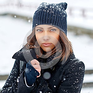 Winter woman posing in casual clothes in white windy park