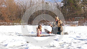 In winter, a woman swims in the river with fish.