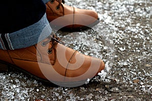 Winter women's shoe on pavement in snow
