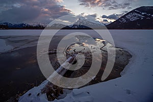 Frozen Vermillion Lake surrounded by Canadian Rocky Mountains.