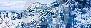 Winter wonderland and magical Christmas landscape. Snowy mountains and forest covered with snow as holiday background