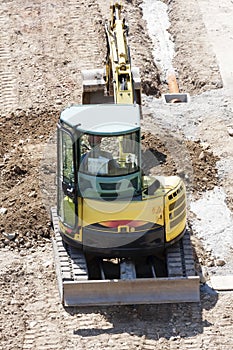 Winter work in construction site with excavator